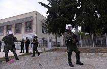 Riot police guard outside a vocational high school after clashes in the northern city of Thessaloniki.
