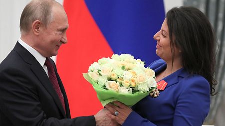 Russian President Vladimir Putin presented RT editor Margarita Simonyan with an award in 2019 