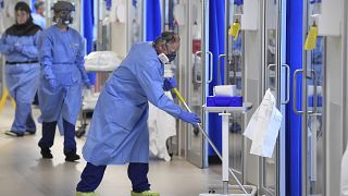 Members of the clinical staff wearing on PPE clean the intensive care unit at the Royal Papworth Hospital in Cambridge, England, Tuesday May 5, 2020.