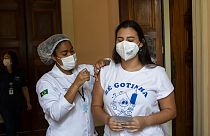 Manuela Mattar is injected with a dose of the Pfizer COVID-19 vaccine, on the first day of a vaccination campaign for 17-year-olds, at a vaccination center in Rio de Janeiro