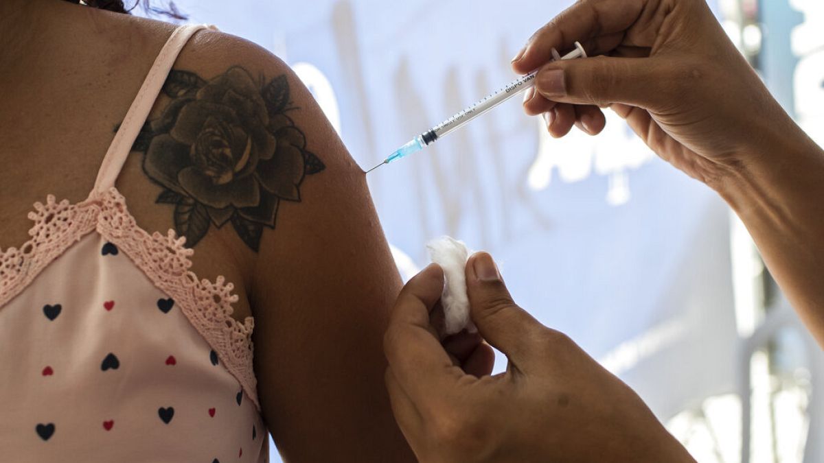 Eine Frau lässt sich während einer Impfkampagne in Sao Joao de Meriti, Brasilien, am Mittwoch, 11. August 2021, gegen COVID-19 impfen.