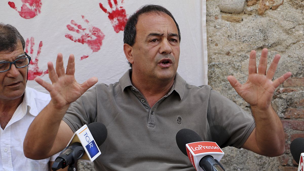 Domenico "Mimmo" Lucano is pictured in front of reporters in September 2019.