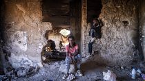 Sudanese girls sit inside an abandoned army outpost near Ieropigi village, northern Greece, at the Greek - Albanian border, on Saturday, Sept. 25, 2021.