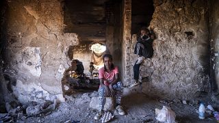 Sudanese girls sit inside an abandoned army outpost near Ieropigi village, northern Greece, at the Greek - Albanian border, on Saturday, Sept. 25, 2021.