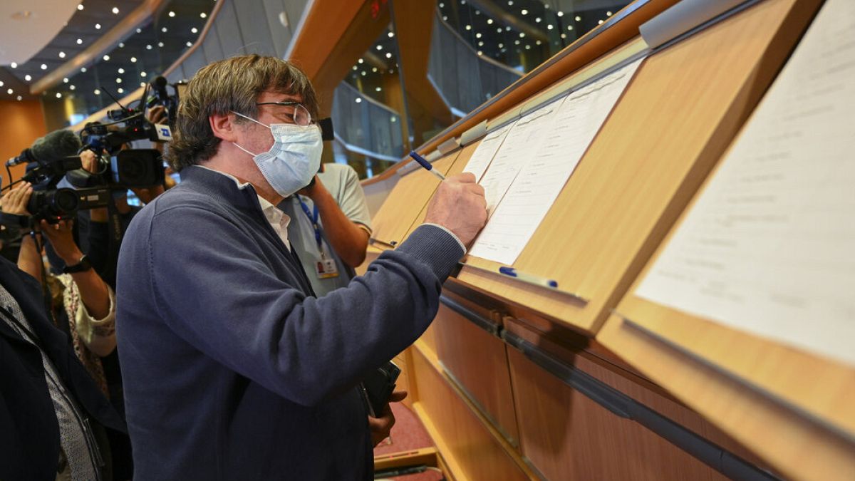 Catalan separatist leader and MEP Carles Puigdemont signs the attendance register prior to attending a committee meeting at the European Parliament in Brussels