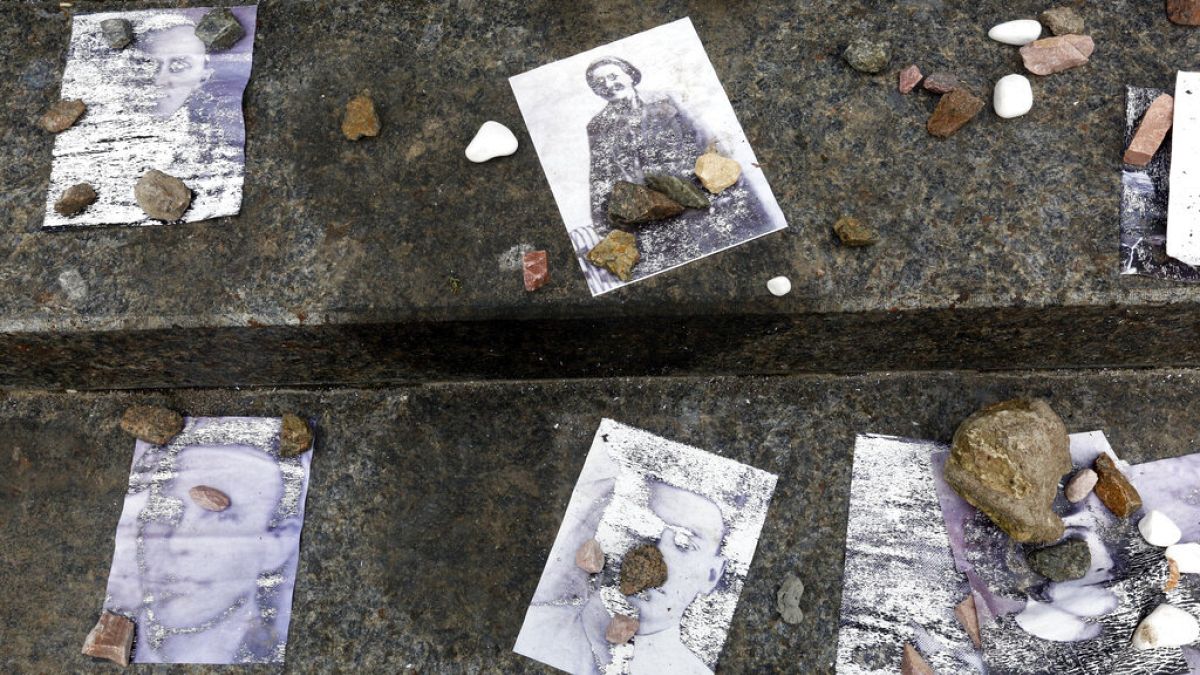 Small stones, on an ancient Jewish tradition to place stones the graves, lay on the photos of victims of the 1941 Babi Yar massacre close to a Babi Yar ravine.