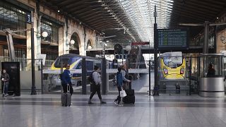 FILE: Travellers walk past Eurostar trains linking Paris to London, at the Gare du Nord station Thursday, March 21, 2019 in Paris.