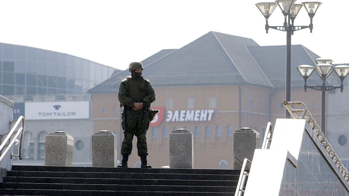 A Belarusian interior ministry soldier guards an empty street in Minsk.