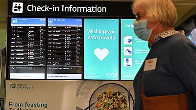 A woman proceeds to the check-in counter for New Zealand flights at Sydney International Airport on April 19, 2021.