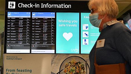 A woman proceeds to the check-in counter for New Zealand flights at Sydney International Airport on April 19, 2021.