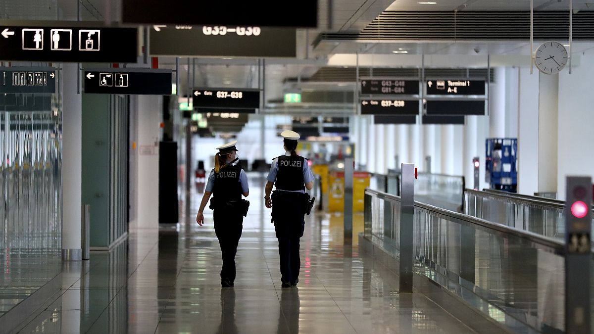 Police officers guard through the deserted airport in Munich.