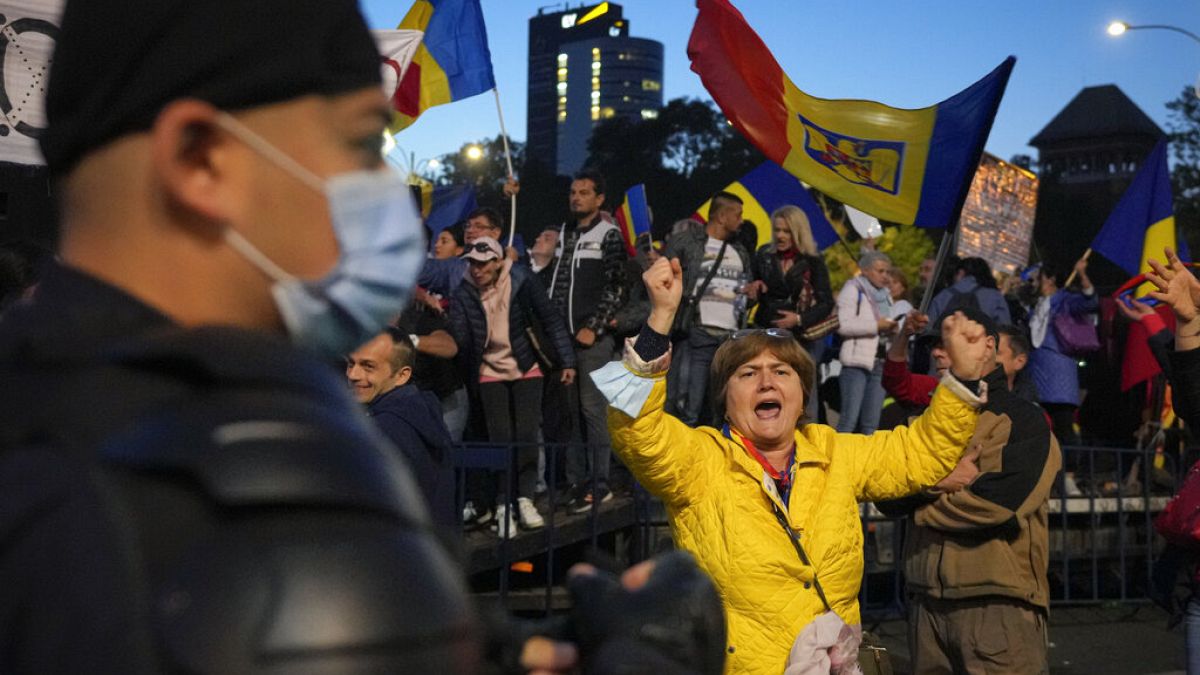 A woman shouts during an anti-government and anti-restrictions protest organized by the far-right Alliance for the Unity of Romanians or AUR, in Bucharest, Romania, Saturday, 
