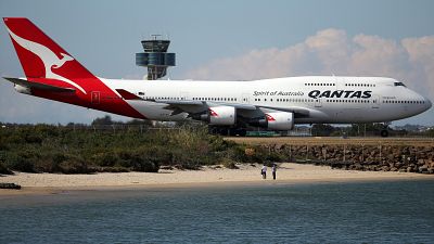 A Qantas plane taxies on the runway at Sydney Airport
