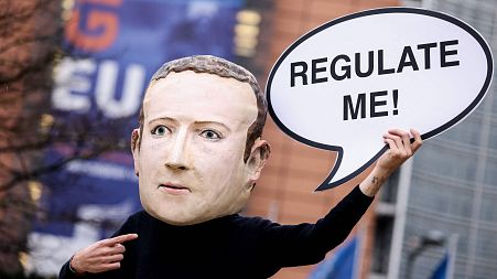 Activists called for the EU to regulate Facebook during a demonstration in December last year