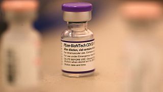 In this file photo taken on October 1, 2021, a vial of Pfizer COVID-19 booster vaccination sits on a table at a vaccination booster shot clinic in San Rafael, California.