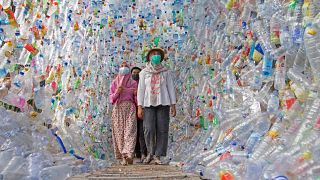 Visitors walk through "Terowongan 4444" at ECOTON's "3F Plastic" exhibition in Gresik, East Java province, Indonesia, September 28, 2021.