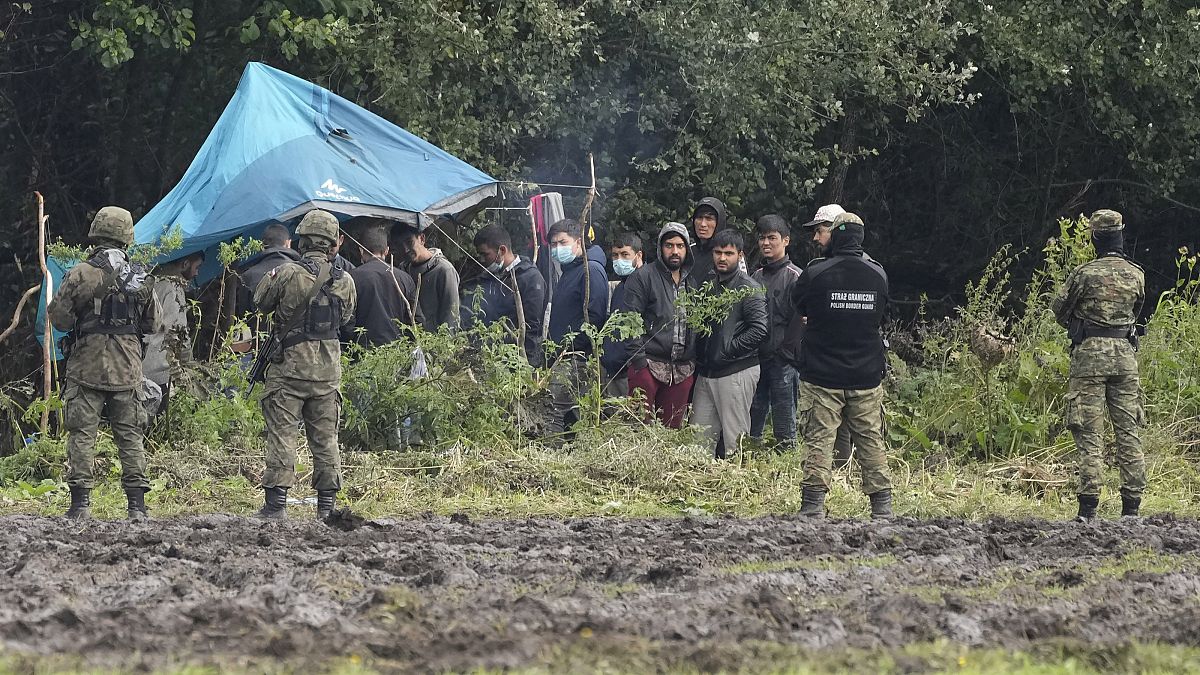 Polish security forces block migrants stuck on the border with Belarus in Usnarz Gorny.