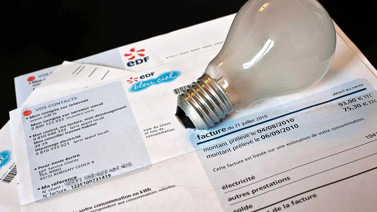 Photo of an incandescent bulb and an electricity bill from France (EDF) from a private individual, taken on August 13, 2010 in Dijon.