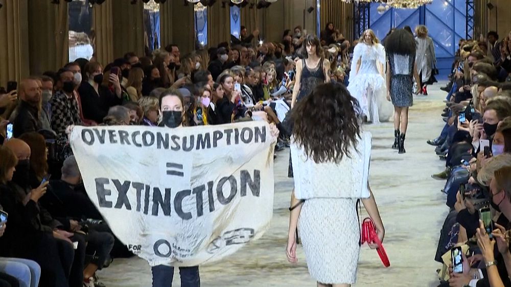 XR activist storms Louis Vuitton's Paris show but it's all smiles