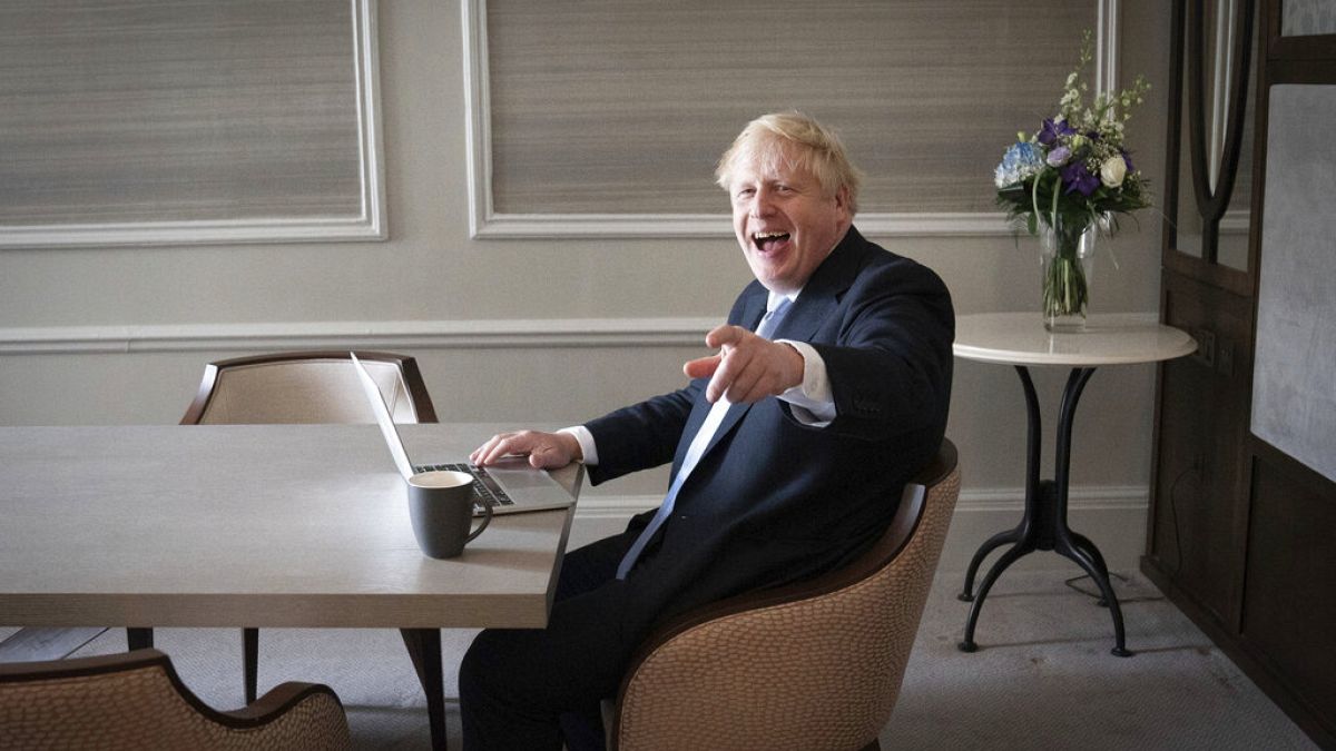 In this Oct. 5, 2021, file photo, Britain's Prime Minister Boris Johnson prepares his keynote speech in his hotel room in Manchester, England,