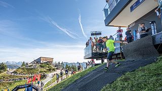 Runners start the race from the Starthaus at the top of the Hahnenkamm ski slope