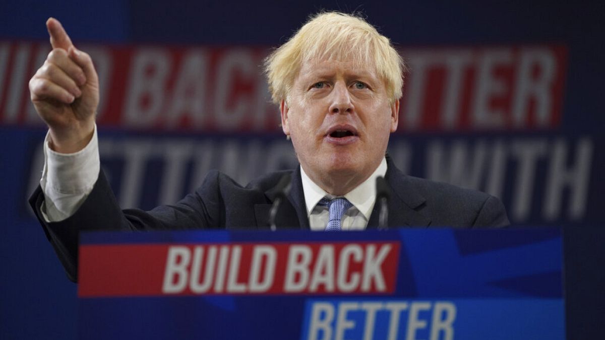 Britain's Prime Minister Boris Johnson gestures as he makes his keynote speech at the Conservative party conference in Manchester, England, Wednesday, Oct. 6, 2021.