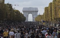Pedestrians walking along the Champs-Elysees on Paris's car-free day 2021,