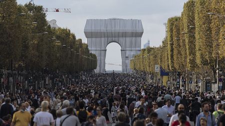 Pedestrians walking along the Champs-Elysees on Paris's car-free day 2021,