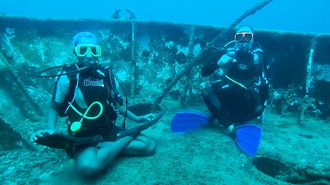Divers practise yoga under the Caribbean sea