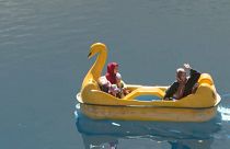 Mujeres afganas saludan desde un bote a pedales, 4/10/2021, Band-e Amir, Afganistán