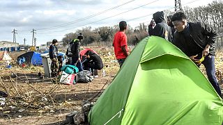 Migrants are seen at a make shift camp in the vicinity of the former 'Jungle' camp site, near the northern French port city of Calais on February 18, 2019.