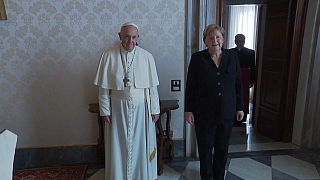 Pope Francis and the outgoing Chancellor pose in the Vatican during their 45 minute long meeting