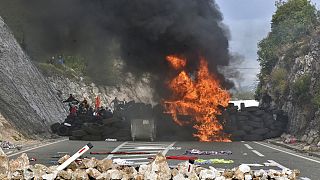 Protesters set fire to car tires at one of the blockades near Cetinje, Montenegro, Sunday, Sept. 5, 2021.