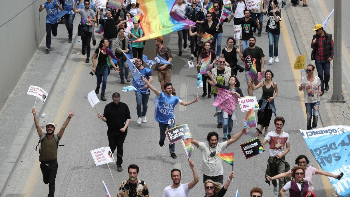 Protesters hold signs and a rainbow flag during a demonstration in Ankara in May 2019.
