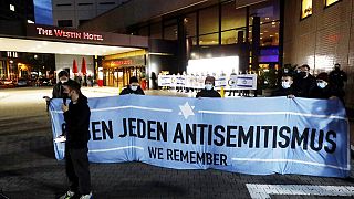 People gather in front of the "Westin Hotel" in Leipzig, Germany, Tuesday, Oct. 5, 2021 to show solidarity with the musician Gil Ofarim. 