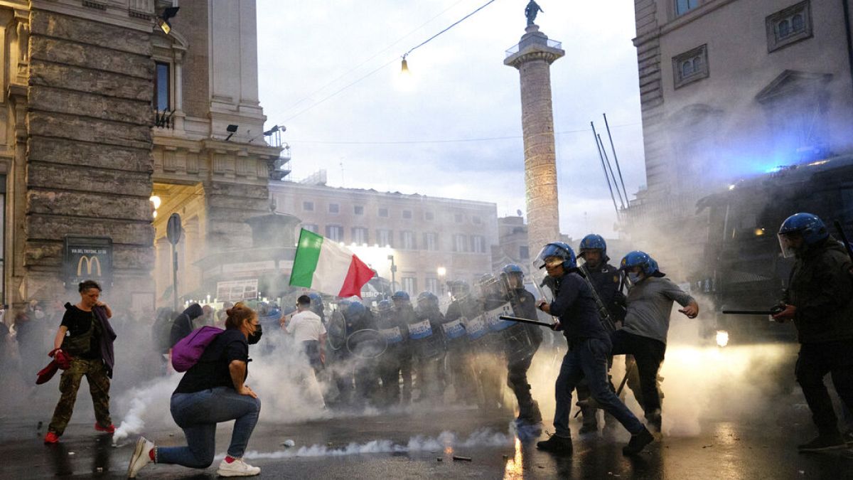 Demonstrators and police clash during a protest, in Rome, Saturday, Oct. 9, 2021. 