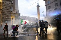 Demonstrators and police clash during a protest, in Rome, Saturday, Oct. 9, 2021.