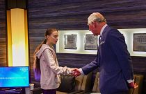 Prince Charles shakes hands with young climate activist Greta Thunberg in Switzerland.
