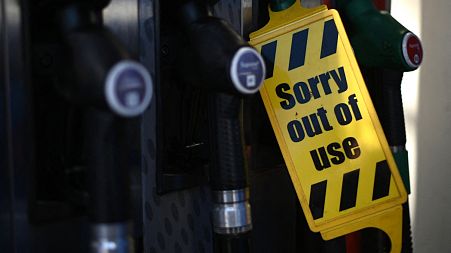 An out of use sign is attached to a pump at an Esso petrol station in east London on September 24
