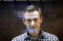 In this Saturday, Feb. 20, 2021, file photo, Russian opposition leader Alexei Navalny looks at photographers standing in the Babuskinsky District Court in Moscow, Russia.