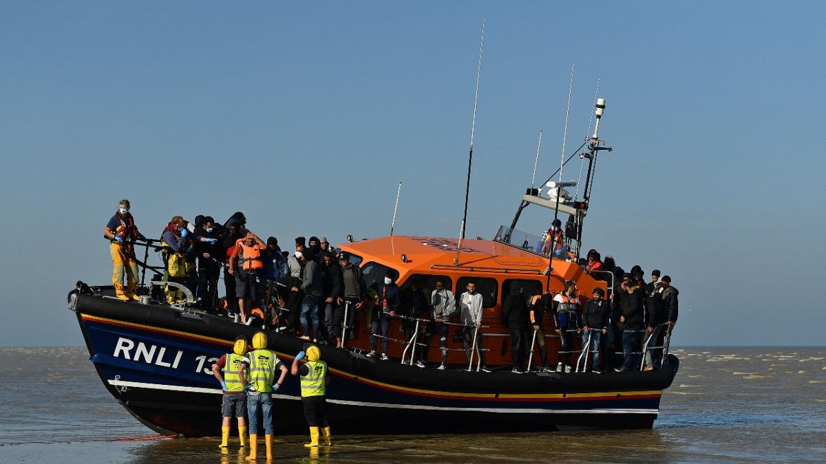 Migrants stand aboard an RNLI (Royal National Lifeboat Institution) lifeboat after being rescued crossing the English channel at Dungeness, England, September 7, 2021.