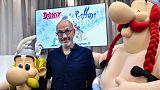 French writer Jean-Yves Ferri poses between effigies of Asterix and Obelix during the presentation of the new "Asterix" album in Paris, on October 11, 2021.