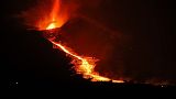 Lava, spewed from Cumbre Vieja volcano, rolls down a hill as it continues to erupt on the Canary Island of La Palma, as seen from Tacande, Spain