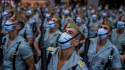 Members of La Legion, an elite unit of the Spanish Army, wait for the start of the military parade