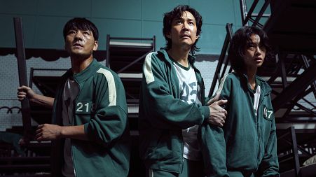 This undated photo released by Netflix shows South Korean cast members, from left, Park Hae-soo, Lee Jung-jae and Jung Ho-yeon in a scene from "Squid Game."
