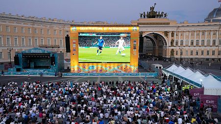 People watch the Euro 2020 soccer championship final match between England and Italy on a giant screen in a fan zone in St. Petersburg, Russia, Sunday, July 11, 2021.