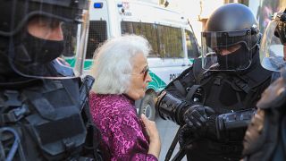 Женщина разговаривает с полицейскими на акции протеста противников вакцинации в Вильнюсе. 10 сентября 2021
