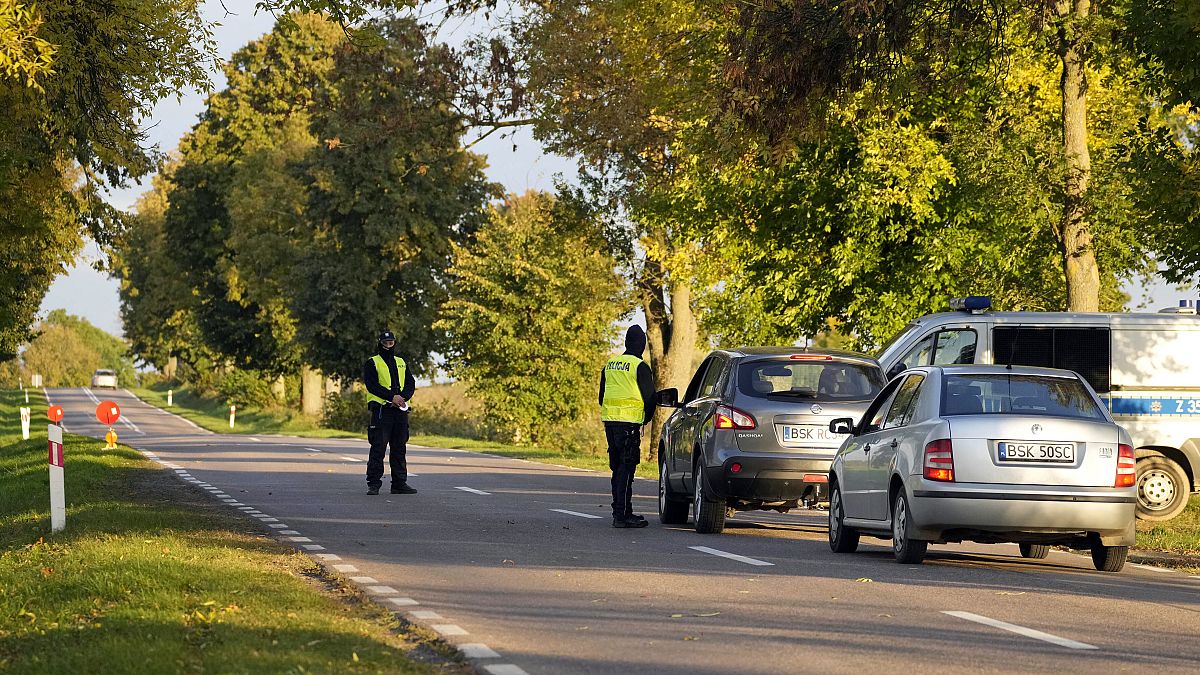 Polish police officers stop vehicles near the Belarusian border.