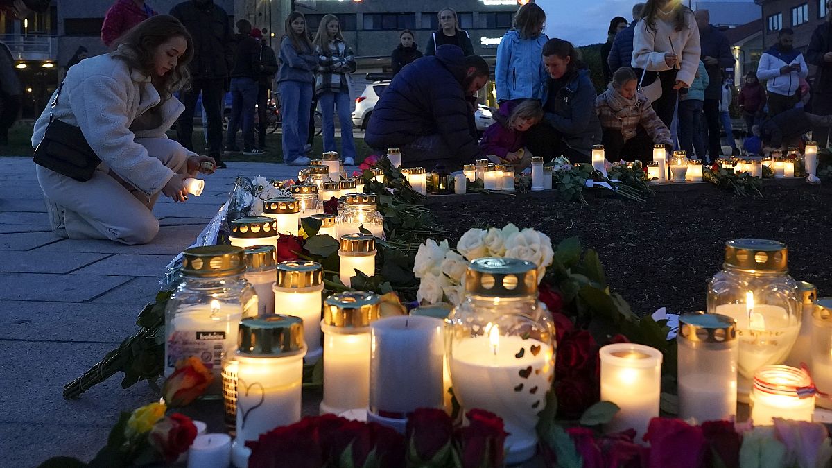 Flowers and candles were left after a man killed several people, in Kongsberg, Norway, Thursday, Oct. 14, 2021