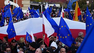 People wave EU and Polish flags in support of Poland's EU membership during a demonstration, in Warsaw, Poland, Sunday, October 10, 2021.